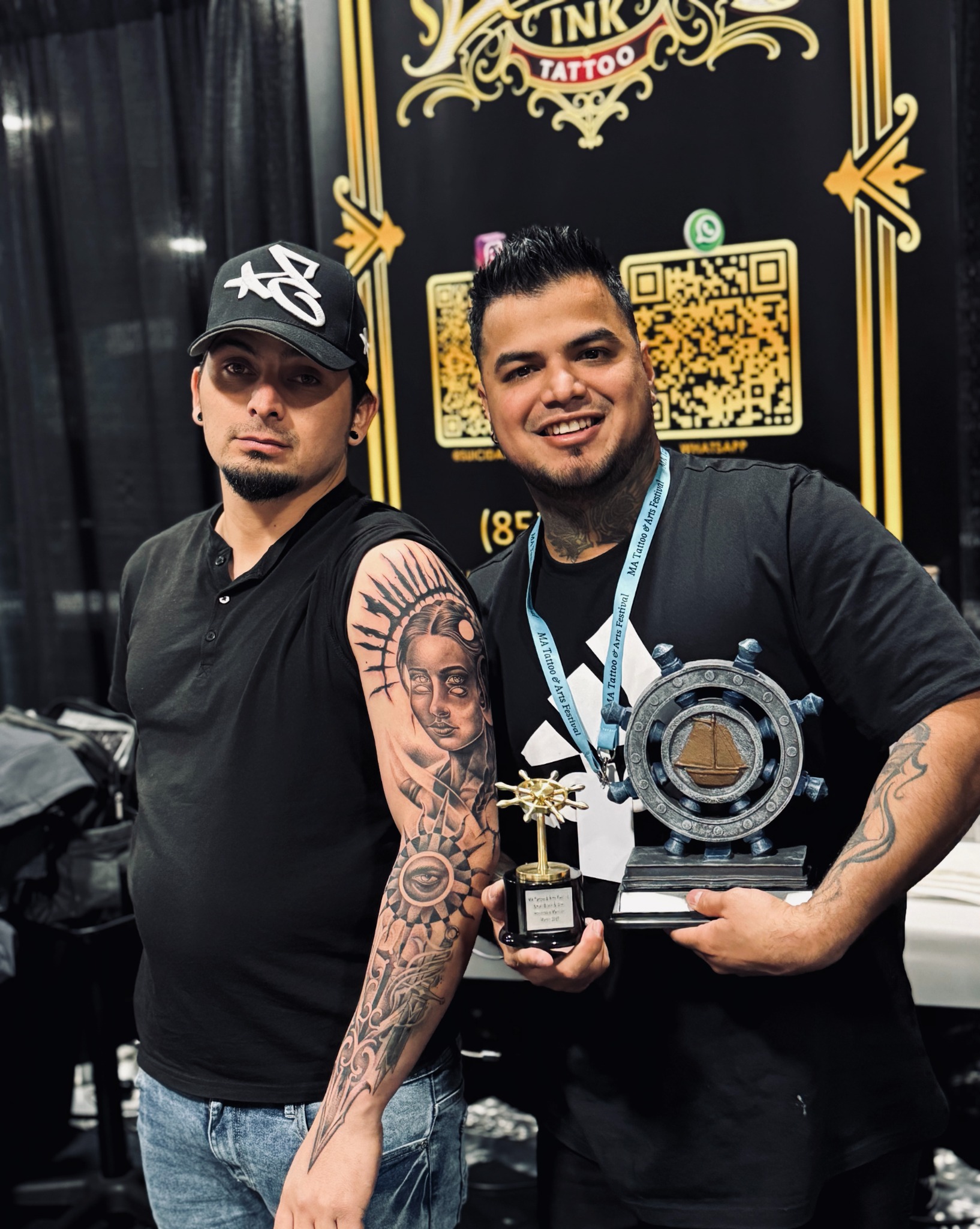 Award-winning tattoo work displayed with Suicida Ink convention trophies
