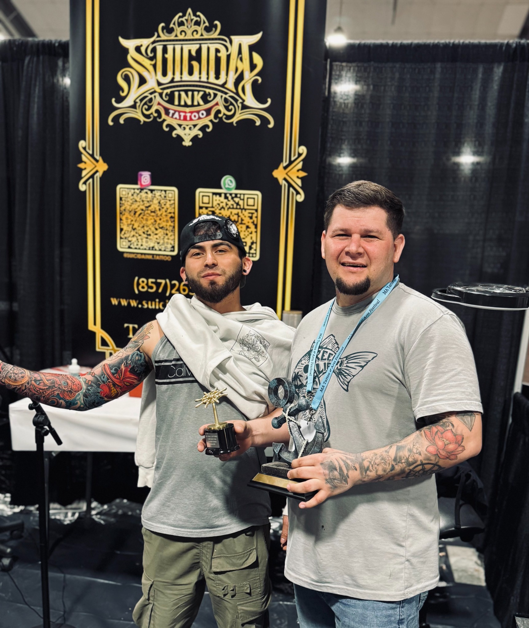 Tattoo convention award recipients holding Suicida Ink trophies